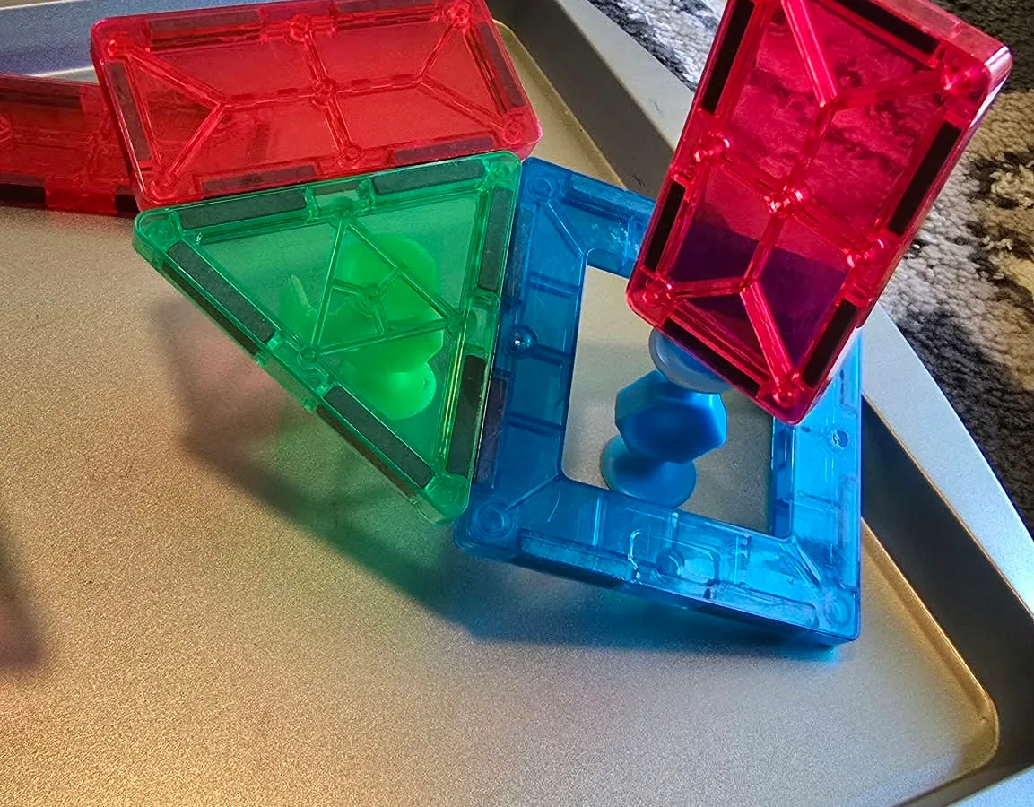 Colorful magnetic-tile structures created during a hands-on Academy activity